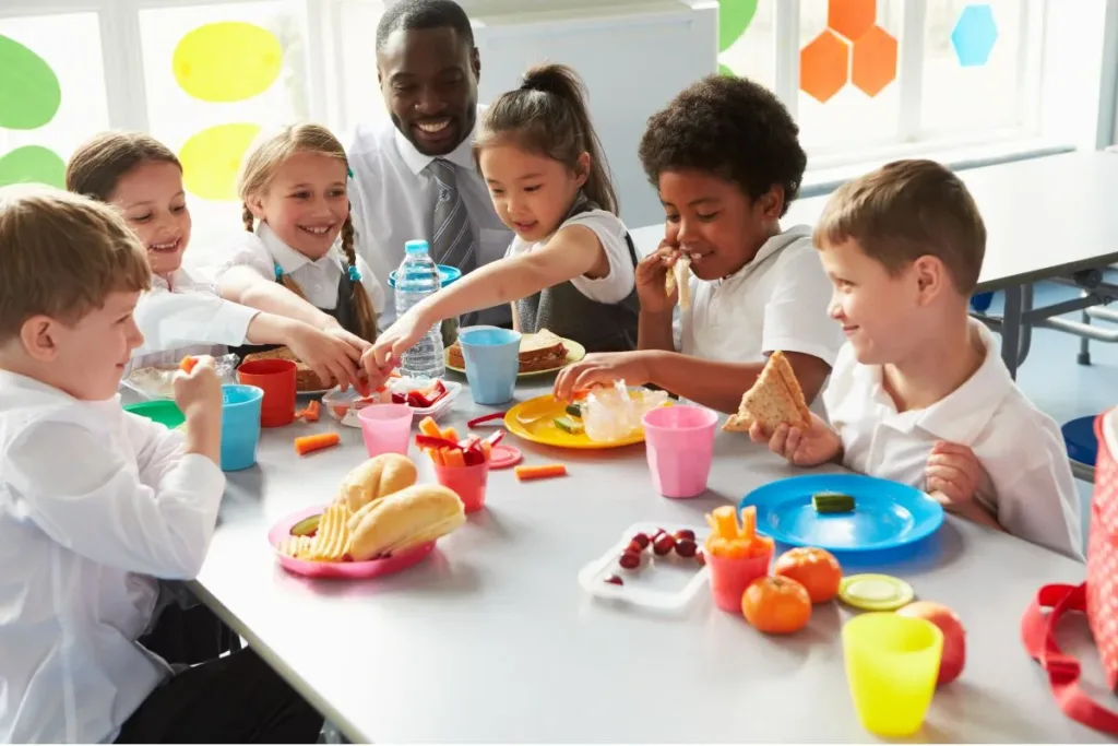 Kids and teacher around lunch table